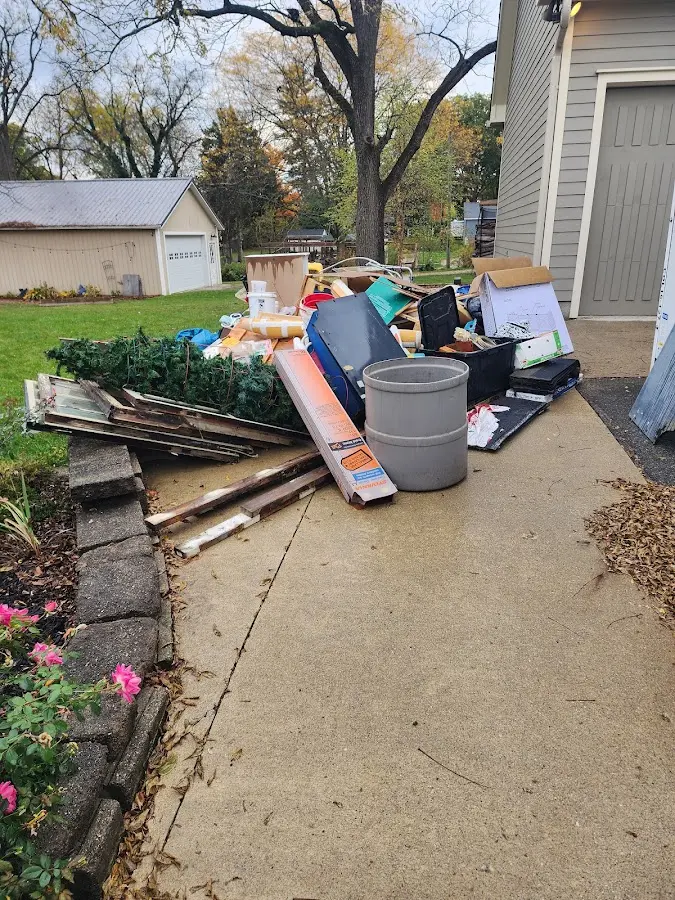 Dumpster being loaded with debris for Estate Cleanout Dumpster Rental in Vestavia Hills